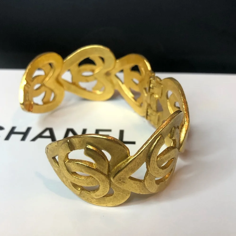 CHANEL Gold Cuff Bracelet with Interlocking CC Open Heart Design